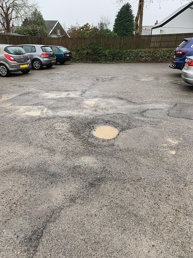 pothole and erosion at the car park